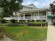 Two-story house with a large porch and landscaping at 56633 Otter Rd, Astor, FL 32102