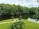 Scenic waterfront view with lush greenery and a fire pit area at 56633 Otter Rd, Astor, FL 32102
