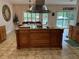 Spacious kitchen island with wood cabinets and granite countertop at 56633 Otter Rd, Astor, FL 32102