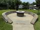 Round fire pit with stone seating wall, near the water at 56633 Otter Rd, Astor, FL 32102