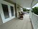 Relaxing balcony with wicker rocking chairs and access to the outdoors at 56633 Otter Rd, Astor, FL 32102