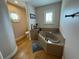 Bathroom with a large soaking tub, toilet, and hardwood floors at 56633 Otter Rd, Astor, FL 32102