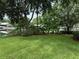 Landscaped backyard with a view of the water at 56633 Otter Rd, Astor, FL 32102