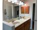 Bathroom with double vanity and wood cabinets at 56633 Otter Rd, Astor, FL 32102