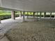 View of the undercarriage of the house, showing the foundation and gravel at 56633 Otter Rd, Astor, FL 32102