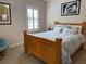 Bedroom with a large wooden bed frame and window with shutters at 56633 Otter Rd, Astor, FL 32102