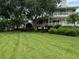 Two-story house with wrap around porch and manicured lawn at 56633 Otter Rd, Astor, FL 32102