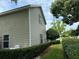 Tan house exterior with windows and neatly trimmed hedges at 56633 Otter Rd, Astor, FL 32102