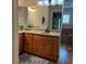 Double vanity bathroom with wood cabinets and a large mirror at 56633 Otter Rd, Astor, FL 32102