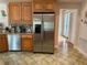 Kitchen with stainless steel appliances and wood cabinets at 56633 Otter Rd, Astor, FL 32102