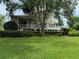 Elevated two story home with wrap-around porch at 56633 Otter Rd, Astor, FL 32102