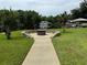 Stone fire pit area with a walkway, overlooking the water at 56633 Otter Rd, Astor, FL 32102