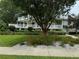 Two-story house with wrap-around porch, mature landscaping, and spacious lawn at 56633 Otter Rd, Astor, FL 32102