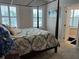Main bedroom with a large four-poster bed and plenty of natural light at 56633 Otter Rd, Astor, FL 32102