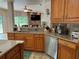 Kitchen with stainless steel appliances and view of living room at 56633 Otter Rd, Astor, FL 32102