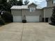 Three-car garage with spacious driveway and stone accents at 56633 Otter Rd, Astor, FL 32102