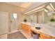 Spa-like bathroom with double vanity, large mirror and a walk in shower at 4818 Se 11Th Pl, Ocala, FL 34471