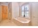 Bathroom featuring a soaking tub, double vanity, and lots of light at 4818 Se 11Th Pl, Ocala, FL 34471