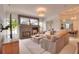 Cozy living room featuring a stone fireplace, large windows, and comfortable seating at 4818 Se 11Th Pl, Ocala, FL 34471