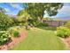 Landscaped backyard with fire pit and lush greenery at 4818 Se 11Th Pl, Ocala, FL 34471