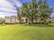 House front with large tree and well-manicured lawn at 4818 Se 11Th Pl, Ocala, FL 34471