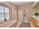 Bathroom with soaking tub, walk-in shower, and neutral color palette at 4818 Se 11Th Pl, Ocala, FL 34471