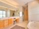 Relaxing bathroom with a soaking tub, large window, and neutral tones at 4818 Se 11Th Pl, Ocala, FL 34471