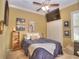 Serene bedroom featuring a plush bed, wall art, and ample closet space at 4818 Se 11Th Pl, Ocala, FL 34471
