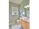 Bathroom with light wood cabinets and a large vanity at 4818 Se 11Th Pl, Ocala, FL 34471