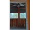 Relaxing screened porch with ceiling fan, offering a view of the woods at 5401 Se 162Nd St # 32, Summerfield, FL 34491