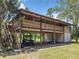 Elevated home with wooden exterior, large yard, and covered parking at 5401 Se 162Nd St # 32, Summerfield, FL 34491