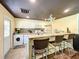Galley kitchen with white appliances and tile backsplash at 5401 Se 162Nd St # 32, Summerfield, FL 34491