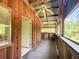 Rustic screened porch with ceiling fan and access to the house at 5401 Se 162Nd St # 32, Summerfield, FL 34491