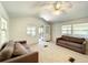 Bright living room with two couches and access to a porch at 5401 Se 162Nd St # 32, Summerfield, FL 34491