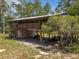 Elevated home with wooden exterior, large yard, and covered parking at 5401 Se 162Nd St # 32, Summerfield, FL 34491