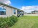 Home's backyard view, showcasing lawn, shed and screened porch at 8857 Sw 50Th Ter, Ocala, FL 34476