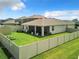 House's backyard with screened patio and well maintained lawn at 8857 Sw 50Th Ter, Ocala, FL 34476