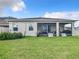 Backyard view of house with large lawn and screened porch at 8857 Sw 50Th Ter, Ocala, FL 34476