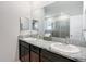 Double vanity bathroom with granite countertops and large mirror at 8857 Sw 50Th Ter, Ocala, FL 34476