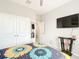 Bright bedroom with double doors and a large TV at 8857 Sw 50Th Ter, Ocala, FL 34476