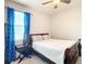 Bedroom with a full bed, featuring blue curtains and nightstand at 8857 Sw 50Th Ter, Ocala, FL 34476