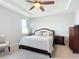 Bright bedroom featuring a king-size bed and ceiling fan at 8857 Sw 50Th Ter, Ocala, FL 34476