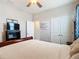 Bedroom with a king bed, featuring a dresser and double doors at 8857 Sw 50Th Ter, Ocala, FL 34476
