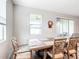 Bright dining room with wooden table and four chairs at 8857 Sw 50Th Ter, Ocala, FL 34476