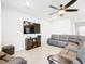 Relaxing living room featuring a large TV and comfortable sectional sofa at 8857 Sw 50Th Ter, Ocala, FL 34476