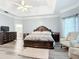 Bright bedroom with hardwood floors, king-size bed, and sitting area at 6615 Se 158Th Pl # 6, Summerfield, FL 34491
