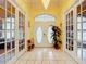 Spacious entryway featuring French doors and a charming chandelier at 6615 Se 158Th Pl # 6, Summerfield, FL 34491