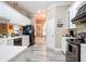 Spacious kitchen featuring white cabinets and a breakfast bar at 6615 Se 158Th Pl # 6, Summerfield, FL 34491