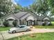 Stunning house exterior with a large driveway at 6615 Se 158Th Pl # 6, Summerfield, FL 34491