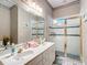 Elegant bathroom with double vanity, large mirror, and shower at 6615 Se 158Th Pl # 6, Summerfield, FL 34491